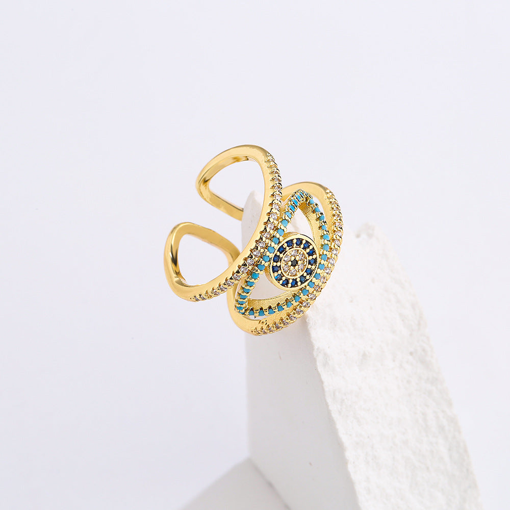 Anello Minimalista Geometrico a Occhio di Allah Traforato per Donna con Base in Rame e Placcatura in Oro con Zirconi Micro-Incastonati