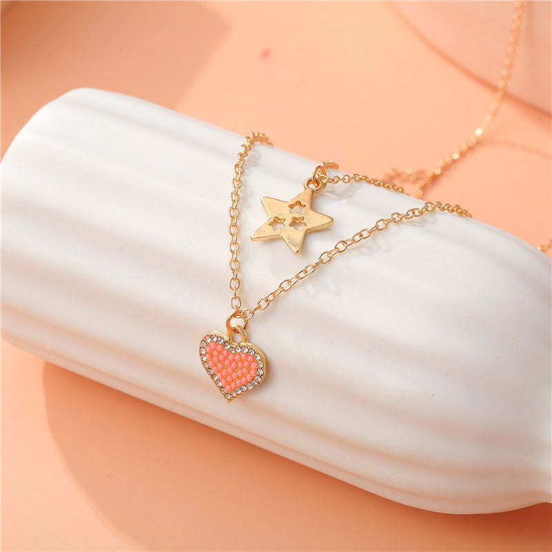 Elegante collana a forma di cuore e stella in lega per bambini con finitura smaltata e design a catena incrociata multistrato