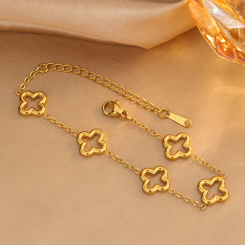 Conjunto de collar, pulsera y pendientes chapados en acero inoxidable con diseño floral hueco elegante de moda para mujer