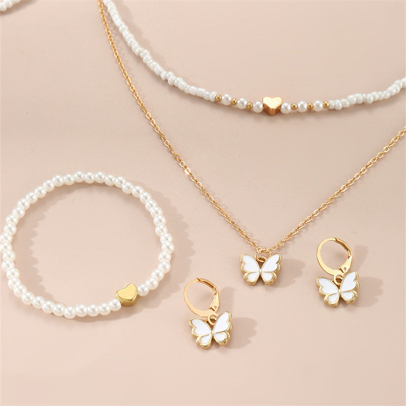 Set collana con ciondolo a farfalla fatto a mano per bambini con perline bianche e ciondolo in lega in stile fresco