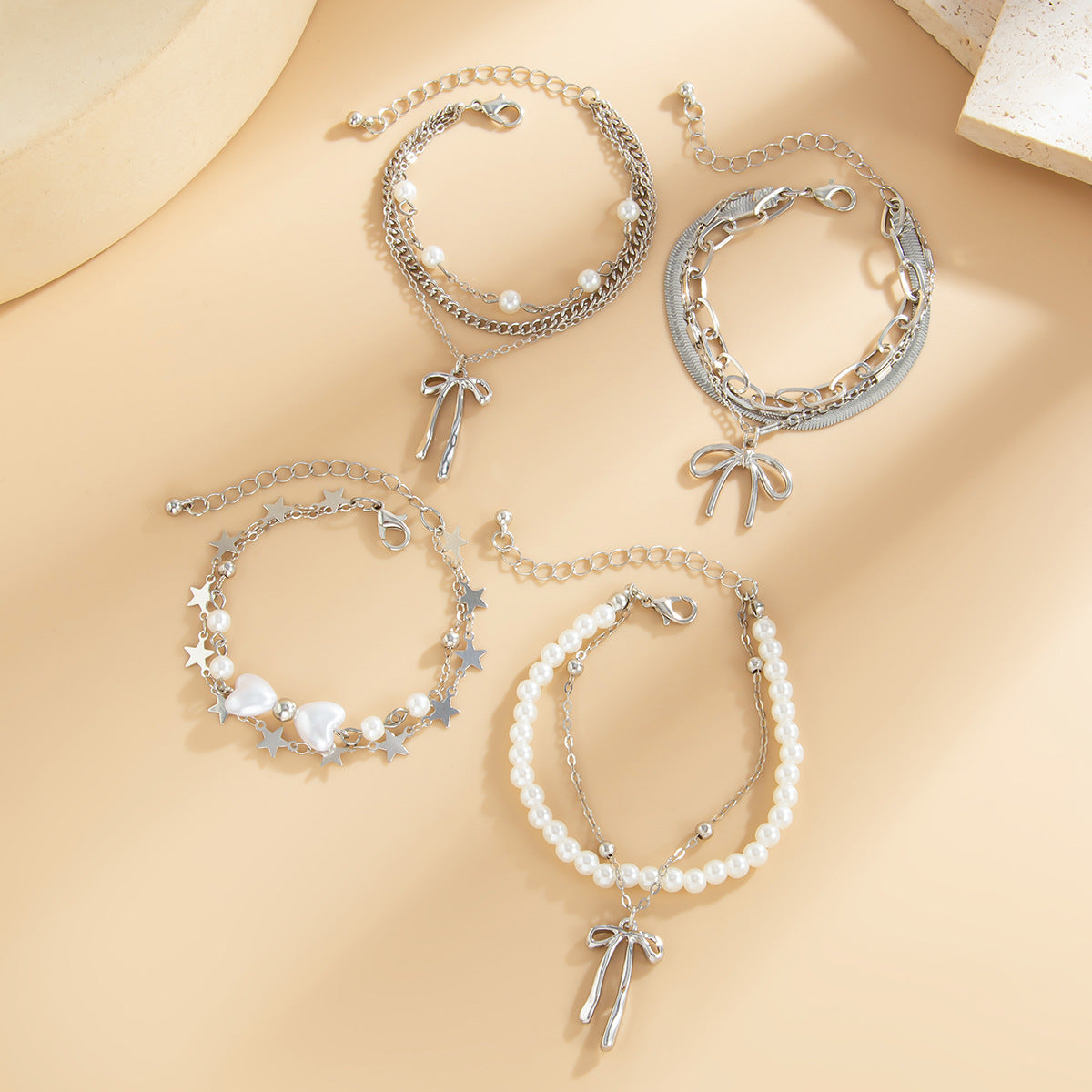 Minimalist Bow Knot and Star-Shaped Pendant Bracelet for Women with Plated Metal and Imitation Pearl Accents