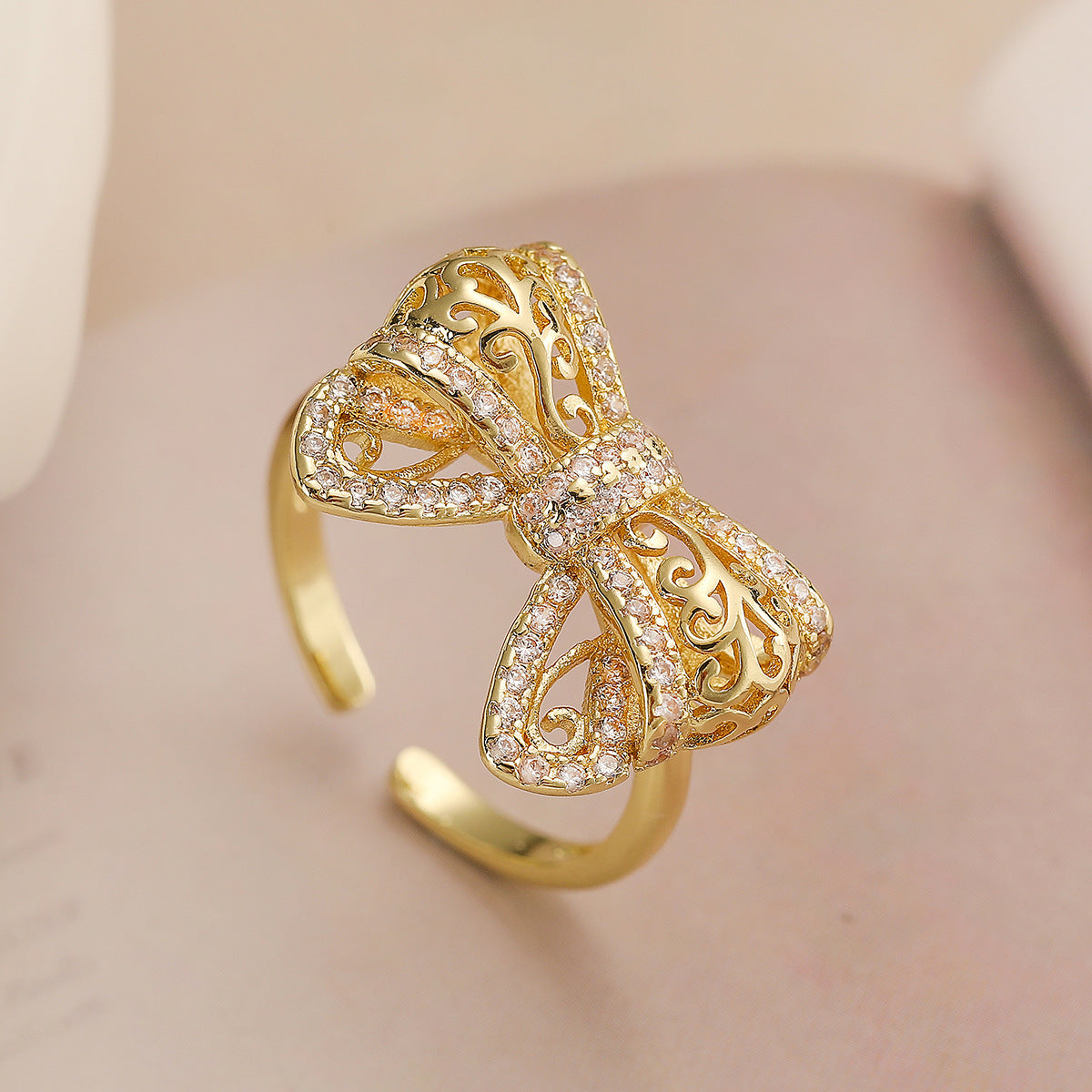 Minimalist Bowknot-Shaped Hollow-Out Copper Ring with 18K Gold Plating and Zircon Inlay for Women