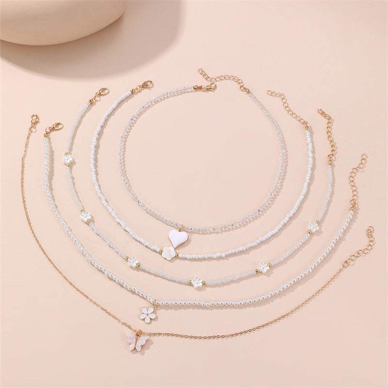 Simpatica collana per bambini con perline di vetro a forma di fiocco e ciondolo in lega su catena di perline rotonde per bambini dai 3 ai 10 anni
