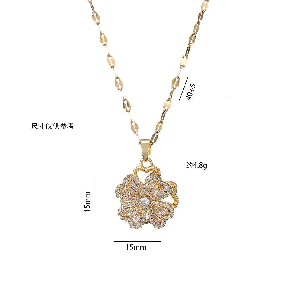 Collana con ciondolo a quadrifoglio rotante da donna in acciaio al titanio con zirconi bianchi micro-incastonati e placcatura in oro su catena ondulata