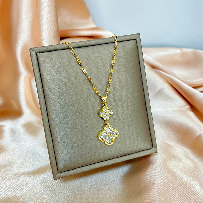 Collana con ciondolo girevole a quadrifoglio in acciaio al titanio con zirconi micropavé da donna