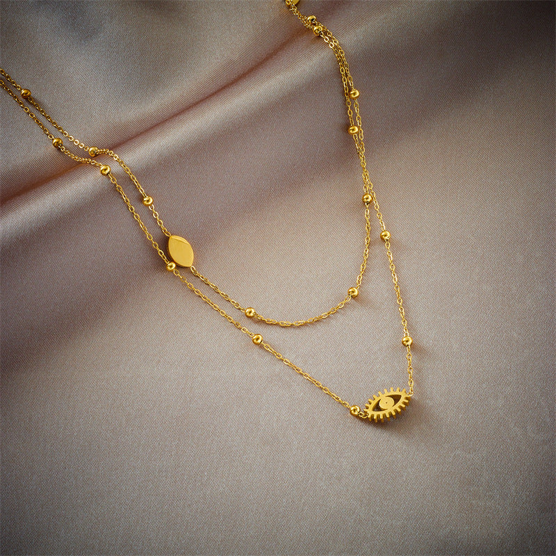 Collar con Colgante de Ojo Azul Hueco de Doble Capa Minimalista de Moda en Acero de Titanio con Cuentas Doradas y Acabado Esmaltado