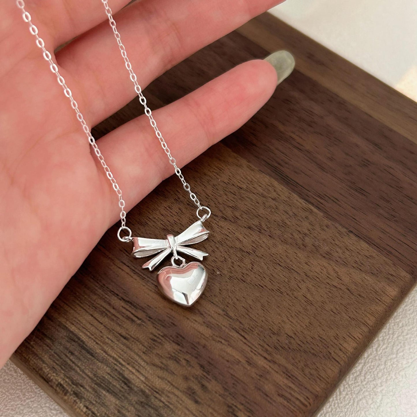 Minimalist Heart and Bow Pendant Necklace in 925 Sterling Silver with Gold Plating on Cross Chain