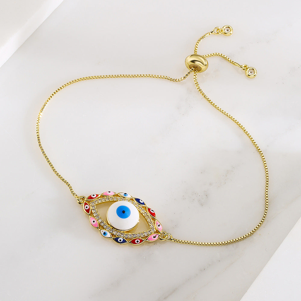 Bracciale da donna stile bohémien con charm a forma di occhio di Nazar, base in rame placcata in vero oro e intarsio di zirconi