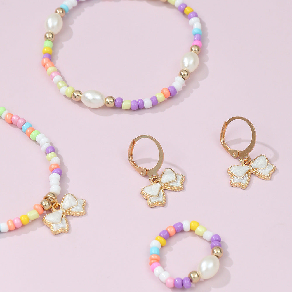 Conjunto de collar, pulsera, anillo y pendientes de aleación con forma de lazo estilo bohemio con acabado esmaltado para niños