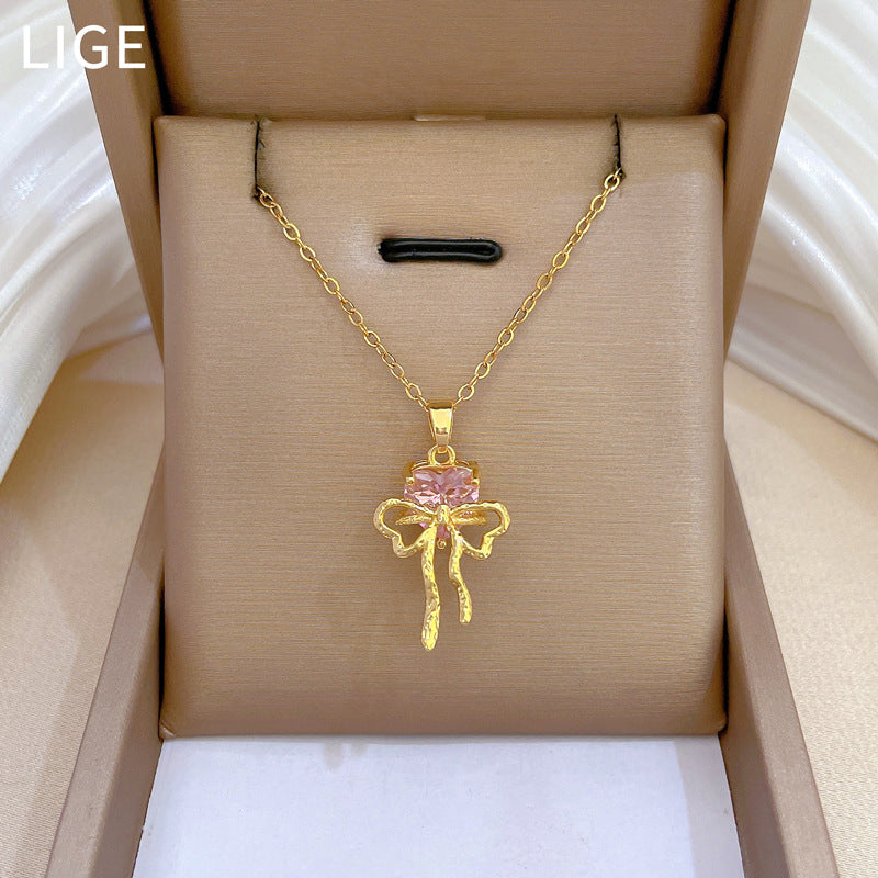 Collana con ciondolo a fiocco rosa con strass da donna in acciaio al titanio con catena a locket delicata