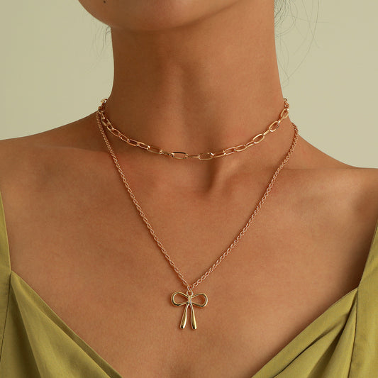 Collana con Pendente a Fiocco in Lega Stile Punk con Finitura Placcata e Catena a Croce a Doppio Strato