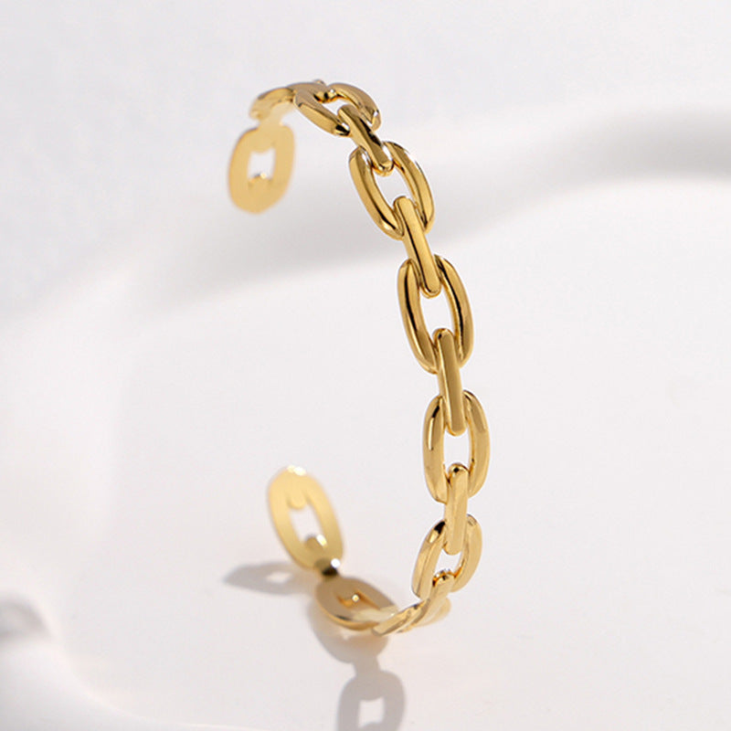 Pulsera Minimalista de Acero de Titanio Abierta para Mujer con Acabado Chapado y Detalle de Cadena