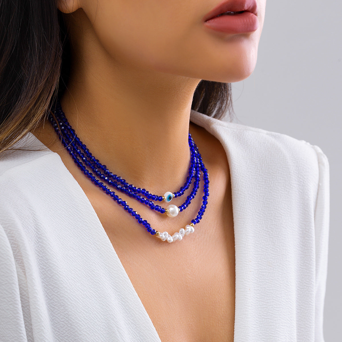 Minimalist Multi-Layer Necklace with Geometric Eye Pendant, Stainless Steel Chain, Tassel Accents, and Electroplated Finish