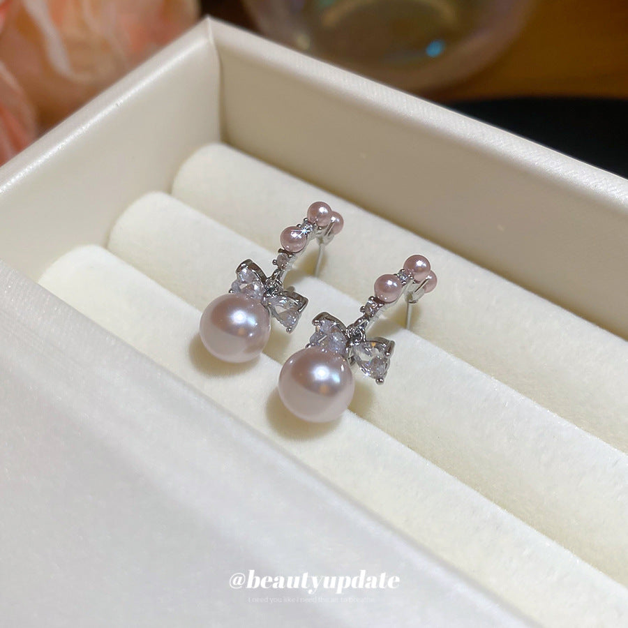 Pendientes de botón con forma de lazo y efecto perla de lujo con incrustaciones de circonita para mujer, poste de acero inoxidable, accesorio de moda minimalista