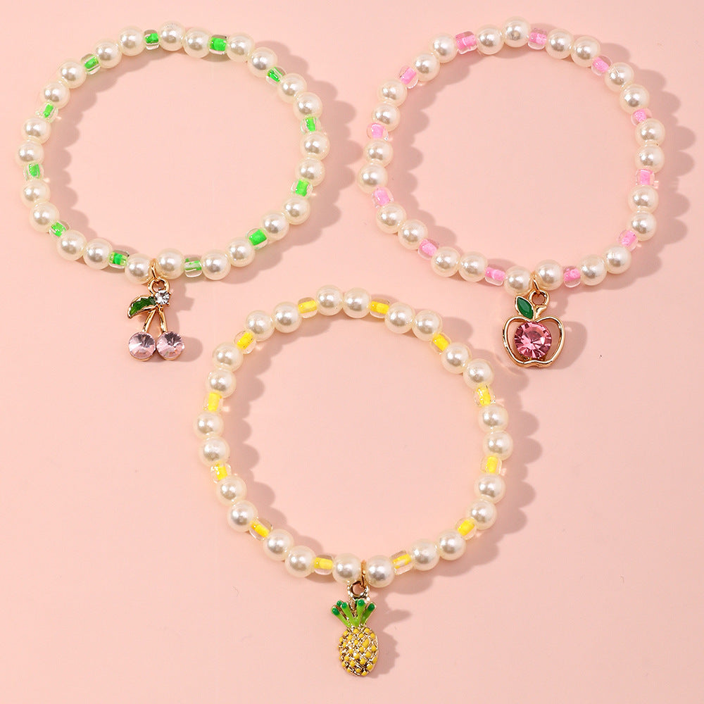 Juego de pulseras infantiles con forma de fruta estilo caricatura, con detalles de perlas y base de aleación para niñas de 6 a 10 años