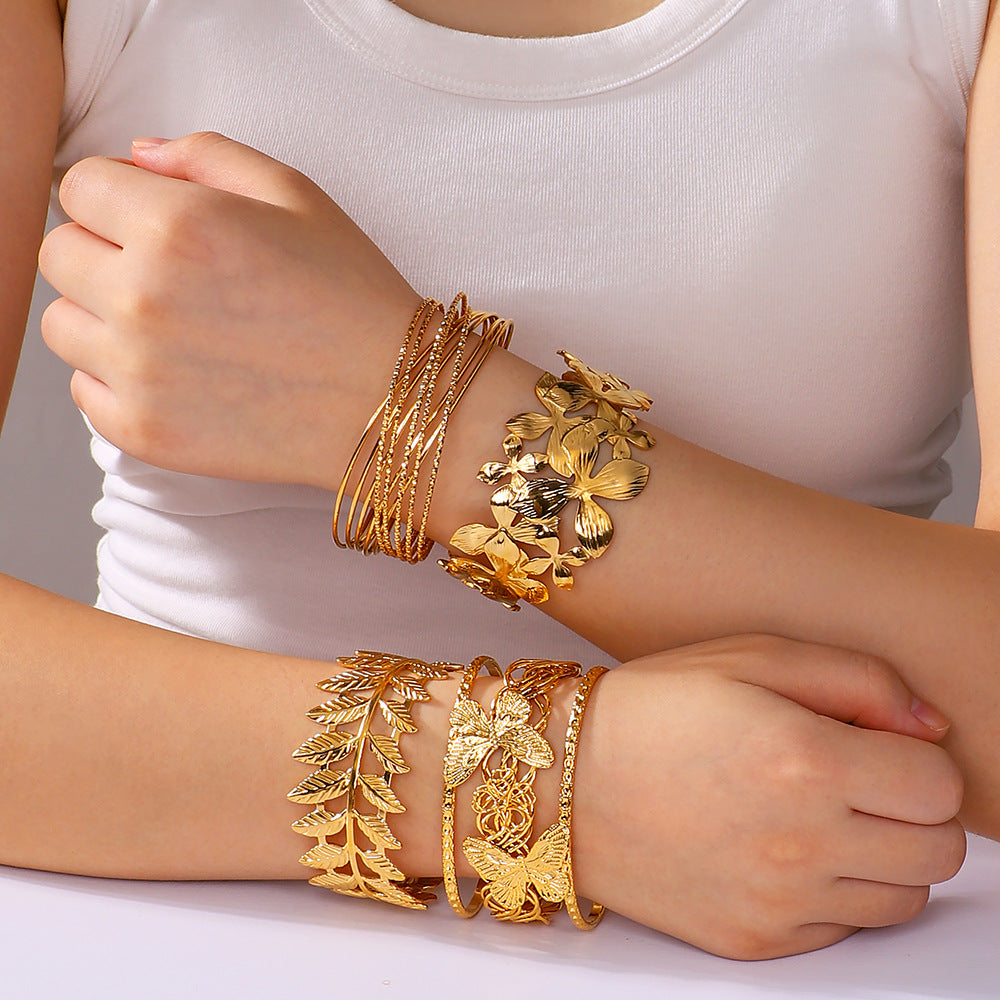 Minimalist Asymmetrical Hollow Flower Starfish Leaf Cuff Bracelet for Women in Titanium Steel with Gold Plating