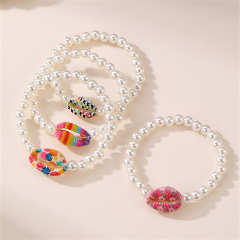 Braccialetto elastico da ragazza fatto a mano con perline in resina a forma di stella, dettagli in perle e stampa floreale