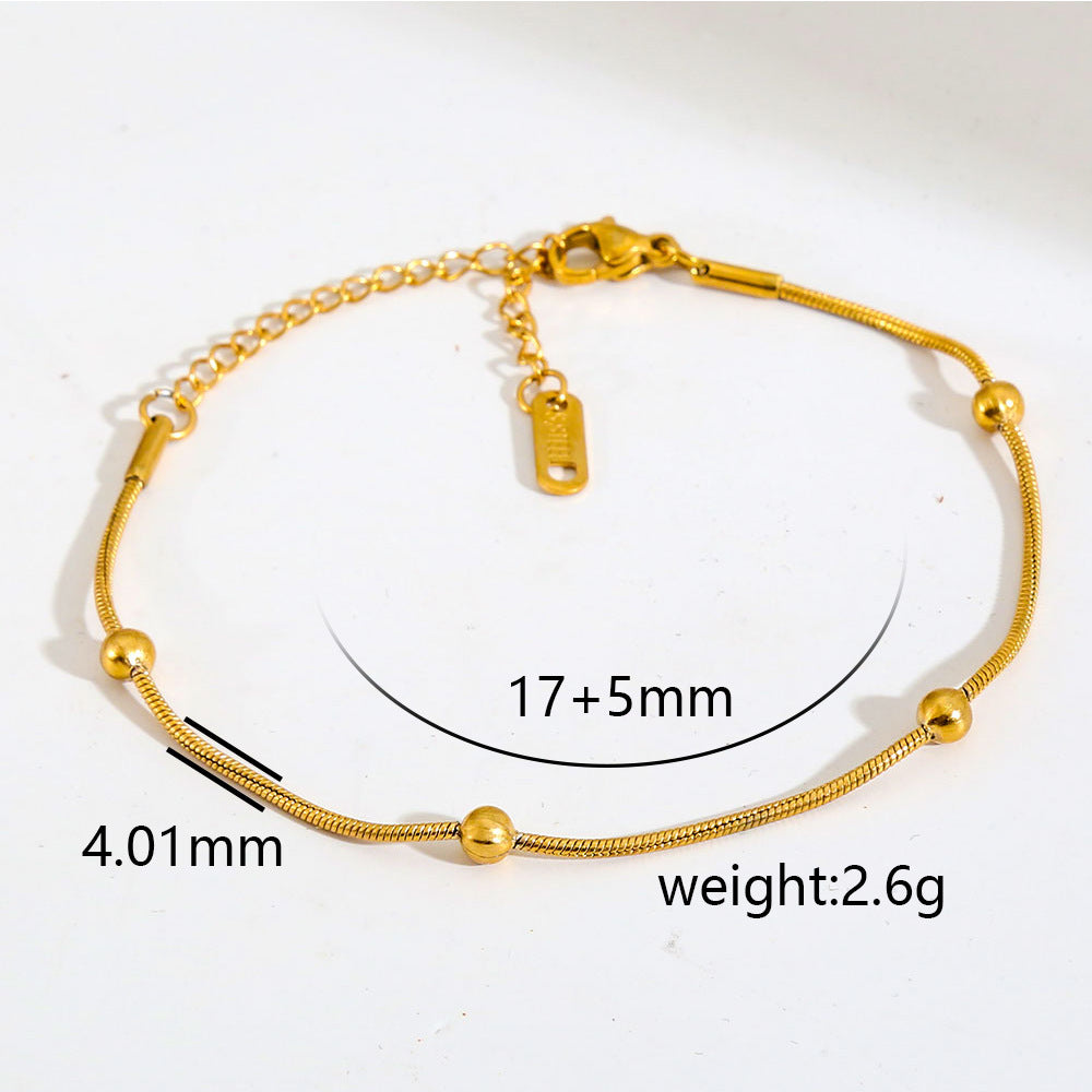 Cavigliera minimalista da donna in acciaio inossidabile placcato oro con piccole perline e ciondolo rotante