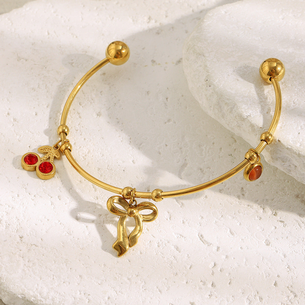 Elegant Fashionable Bowknot-Shaped Stainless Steel Plated 18K Gold C-Shaped Bracelet with Red Rhinestone Cherry Accent