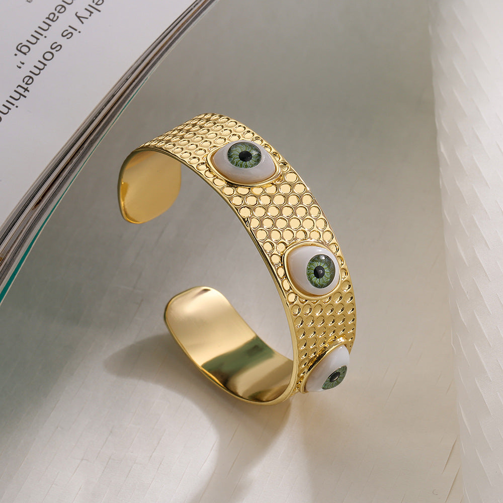 Bracciale rigido aperto geometrico da donna con base in rame e placcatura in oro 18 carati con design a occhio di Allah
