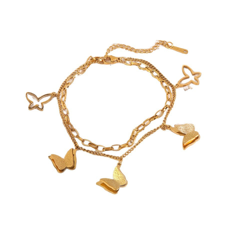 Bracciale a croce elegante a farfalla in acciaio inossidabile placcato oro con zirconi cubici da donna