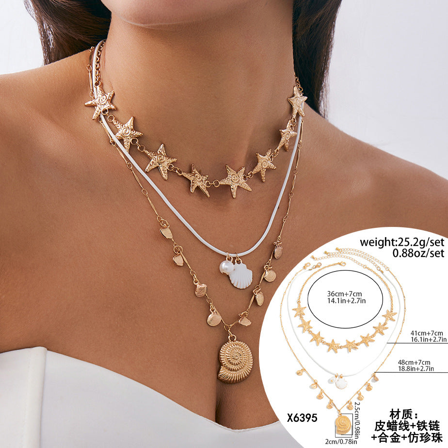 Collana girocollo con ciondolo a stella e a cuore in lega, perle imitate e nappe, stile vacanza
