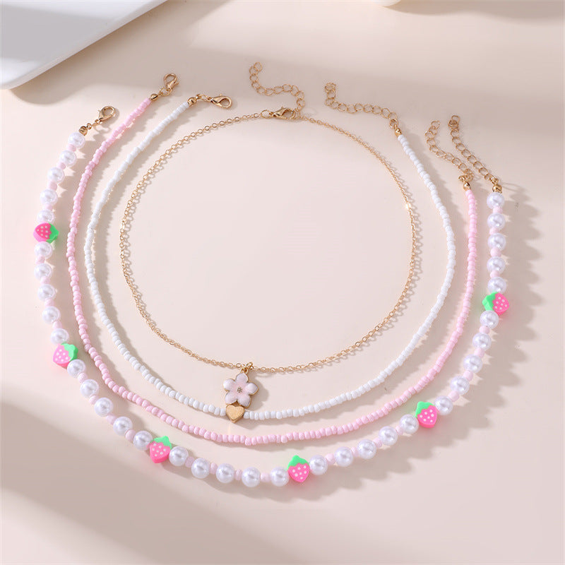Collar con colgante de lazo y mariposa minimalista para niños, fabricado en resina con acabado esmaltado en tono rosa
