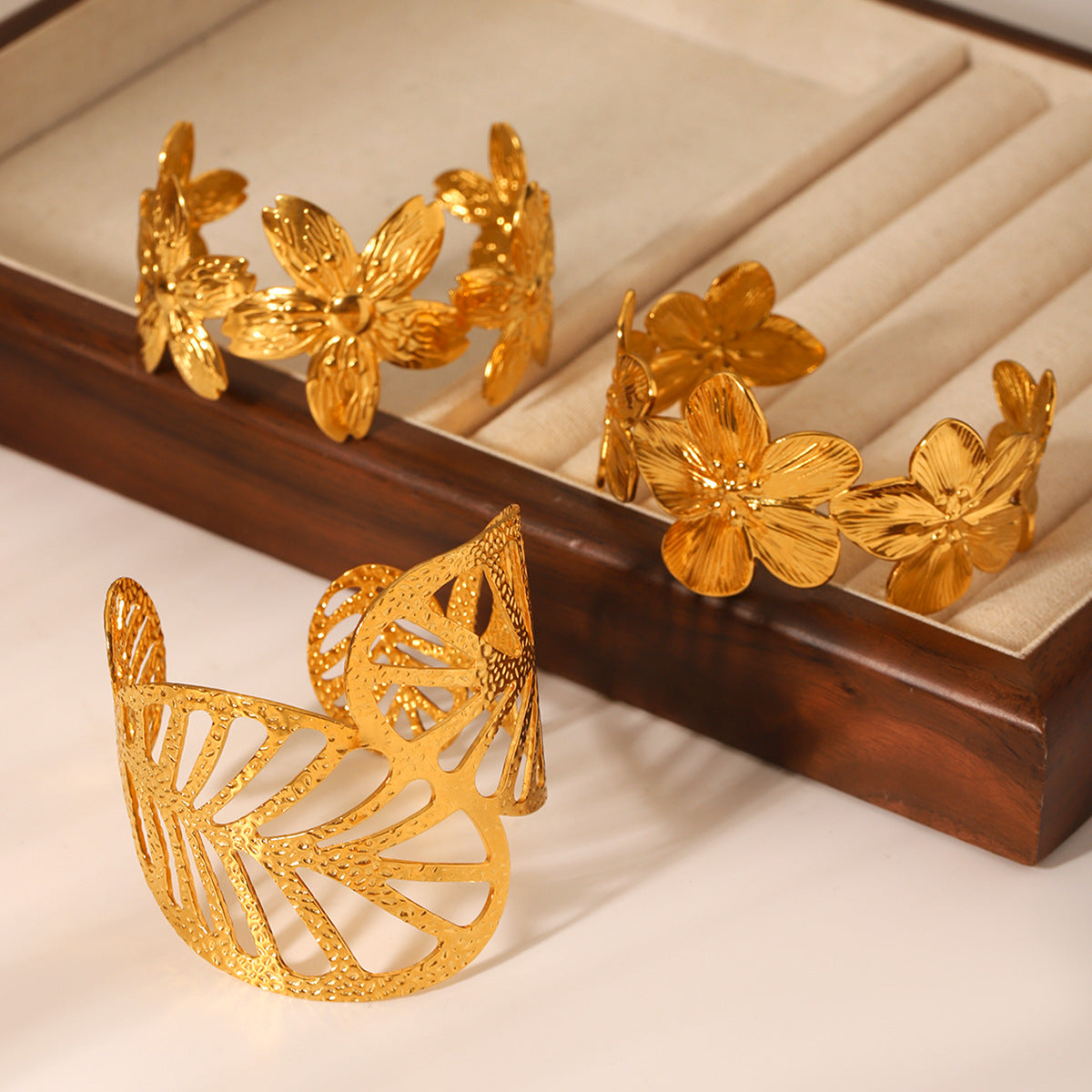 Trendy 18K Gold Plated Stainless Steel Open Cuff Bracelet with Hollow Leaf Flower Bowknot Design