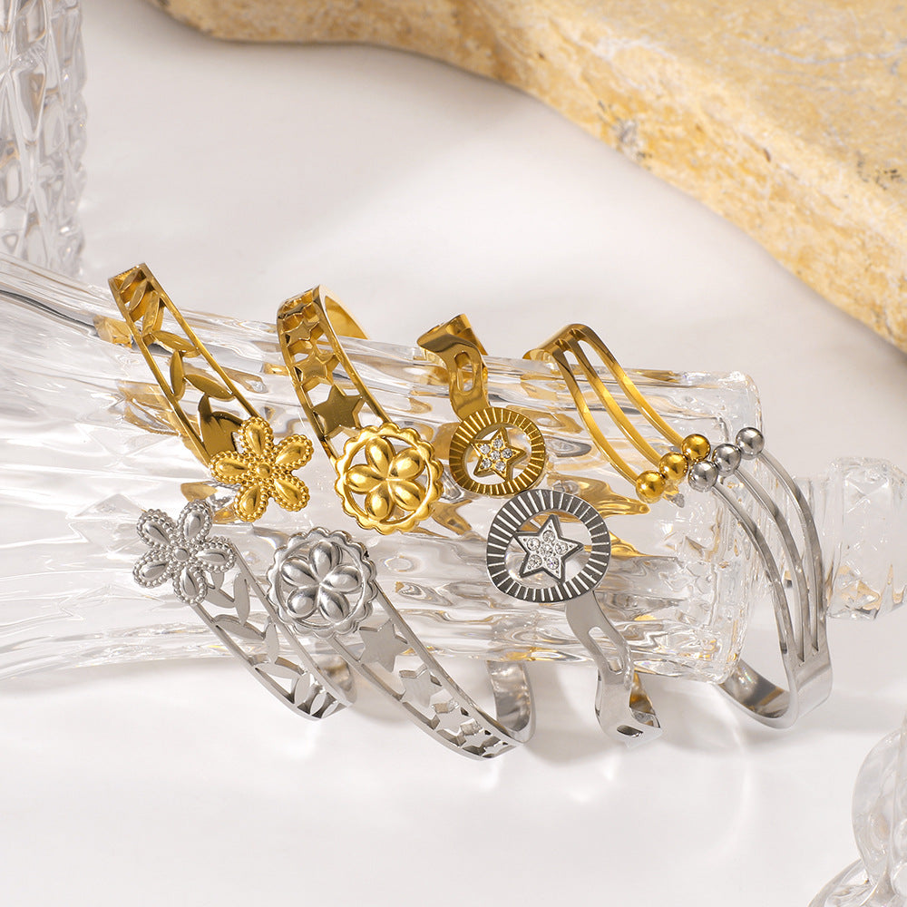 Minimalist Asymmetrical Stainless Steel Bracelet with Gold Plating Featuring Floral and Star Motifs and Linear Design