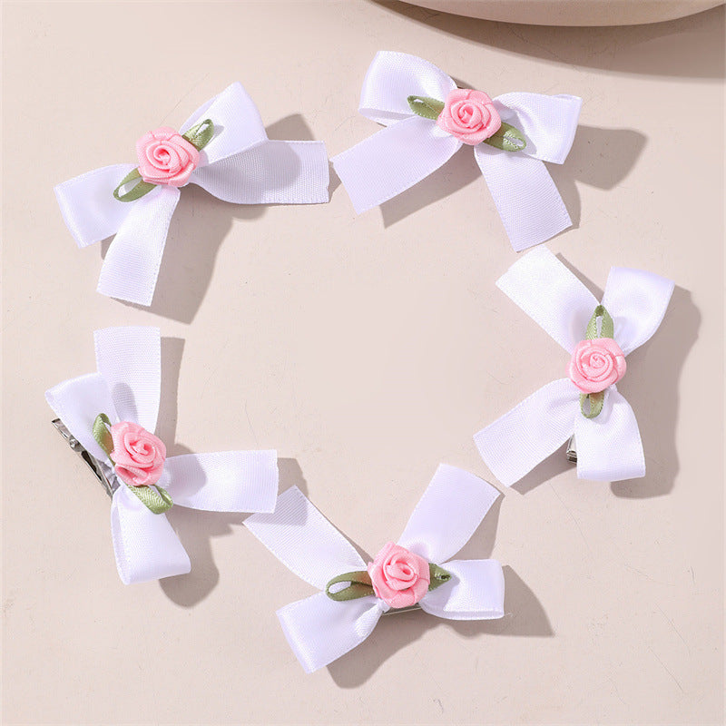 Juego de pinzas para el pelo con forma de lazo estilo dulce para niños con motivos florales y de rosas en rosa y morado sobre fondo de hojas verdes