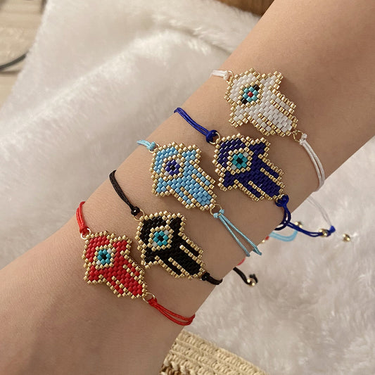 Bracciale da donna fatto a mano, con perline di vetro intrecciate e ciondolo a forma di occhio turco