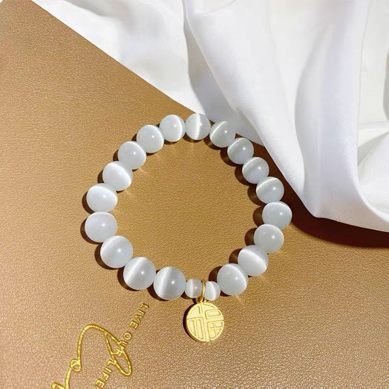 Bracciale da donna placcato in titanio e acciaio, con design floreale minimalista, pietra occhio di gatto e ciondolo portafortuna Fu