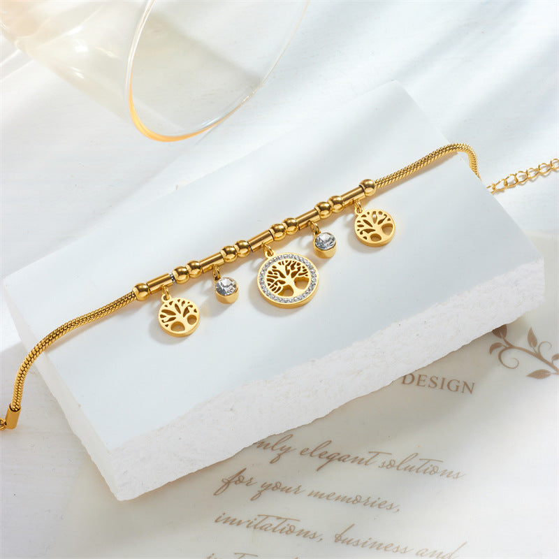 Braccialetto da donna con ciondolo albero della vita traforato in acciaio inossidabile, ispirato al vintage, con intarsi di strass e finitura placcata