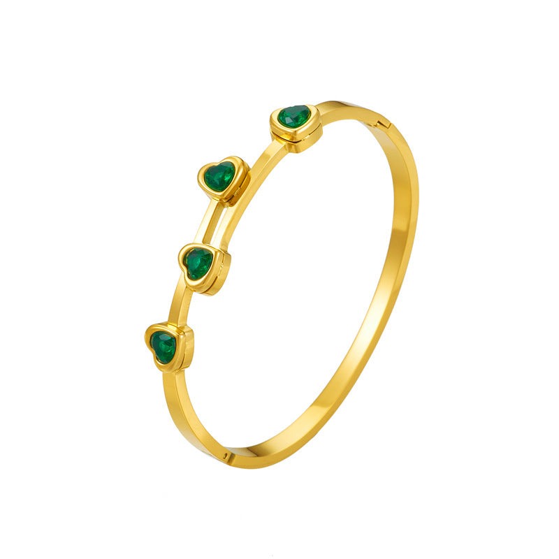 Elegante pulsera de titanio chapado en oro con circonitas en forma de corazón para mujer