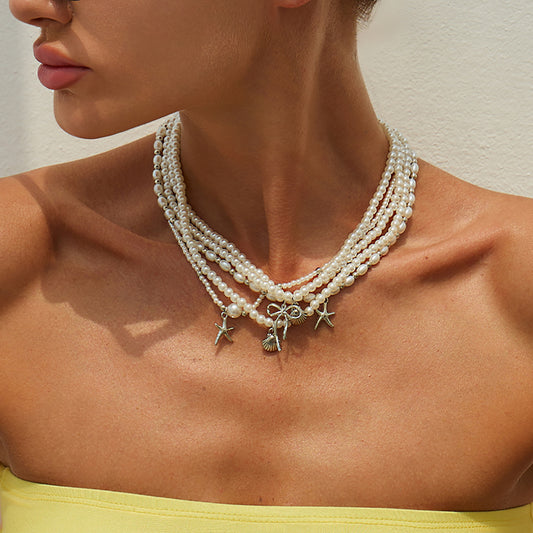 Collana pendente minimalista con stella e fiocco per donna con perle finte su catena di perline