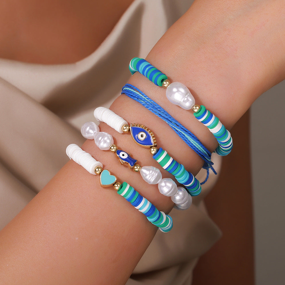 Braccialetto da donna dolce e carino a tema oceano in argilla polimerica e perle con pesci smaltati e occhi a forma di cuore