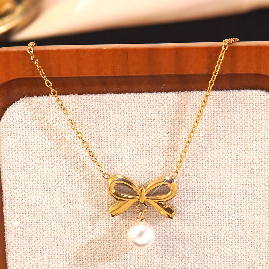 Elegante parure collana e orecchini in acciaio inossidabile con fiocco e perle, con catena a maglie forzatine