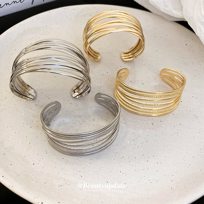 Bracciale rigido aperto geometrico minimalista in lega con finitura placcata per donna