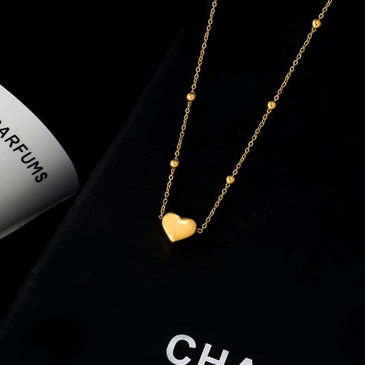 Tobillera minimalista geométrica de acero de titanio para mujer con cuentas redondas y dije de corazón