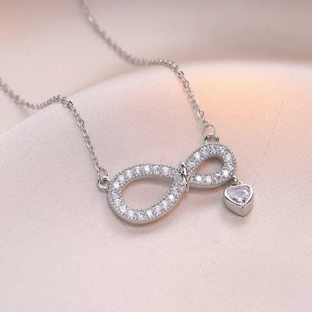 Collar de titanio minimalista con diseño de corazón en forma de ocho, microincrustaciones de circonia y colgante de cristal para mujer