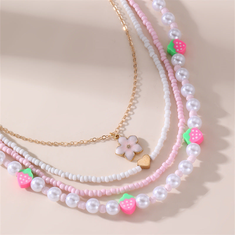 Collar con colgante de lazo y mariposa minimalista para niños, fabricado en resina con acabado esmaltado en tono rosa