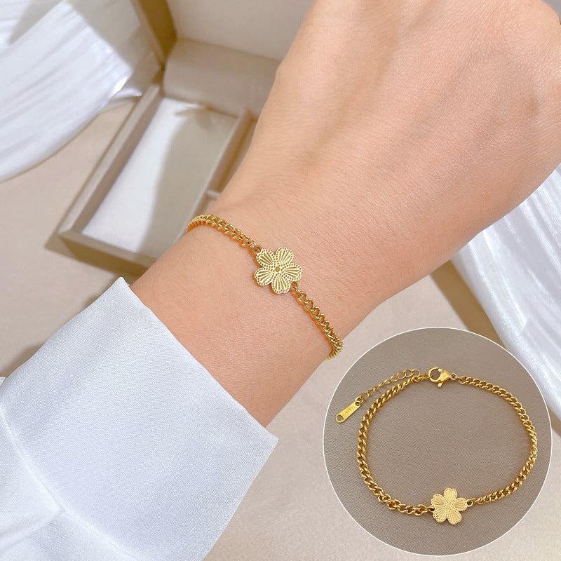 Minimalist Titanium Steel Five-Petal Flower Hand Chain for Women with Gold Plating and Wavy Texture Design