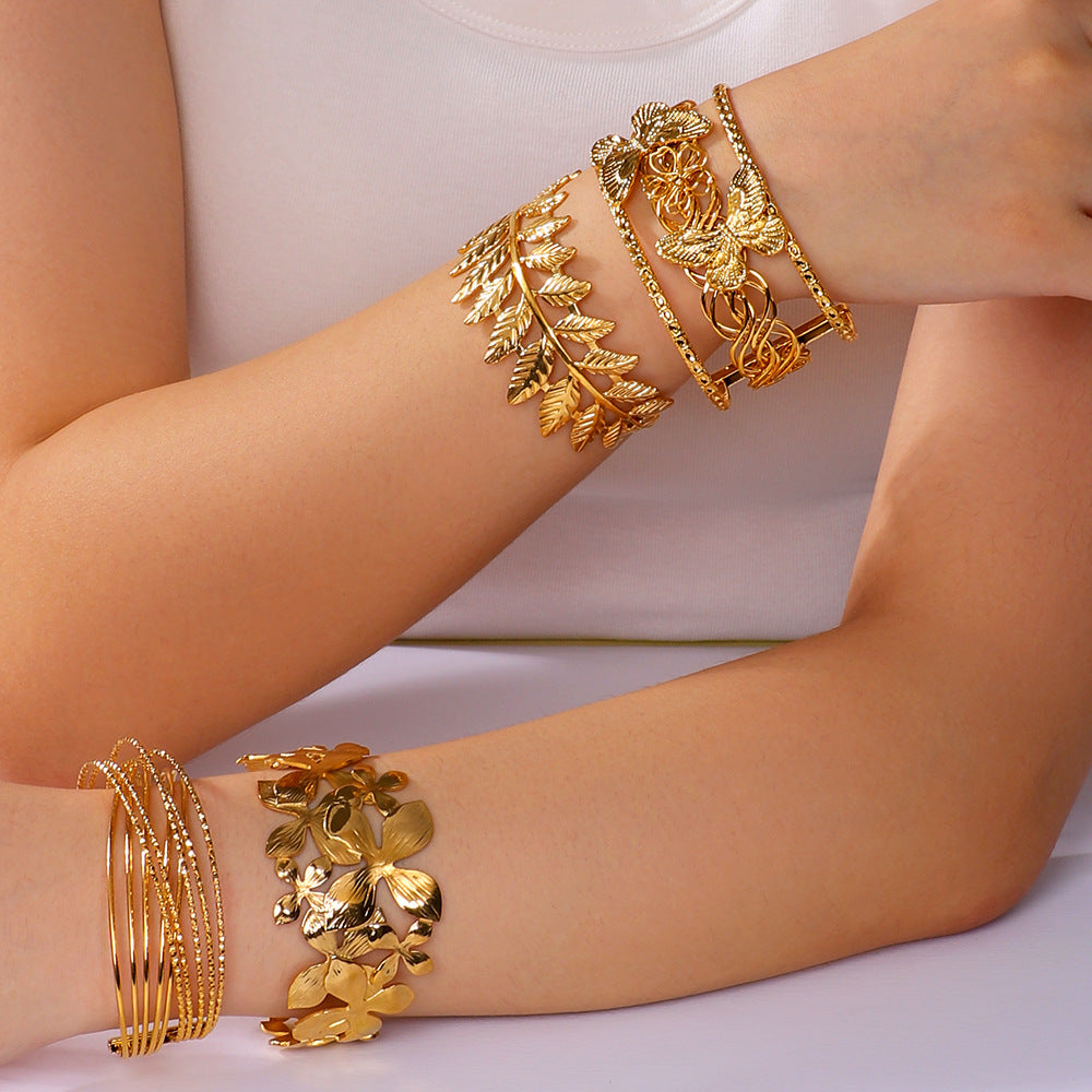 Minimalist Asymmetrical Hollow Flower Starfish Leaf Cuff Bracelet for Women in Titanium Steel with Gold Plating