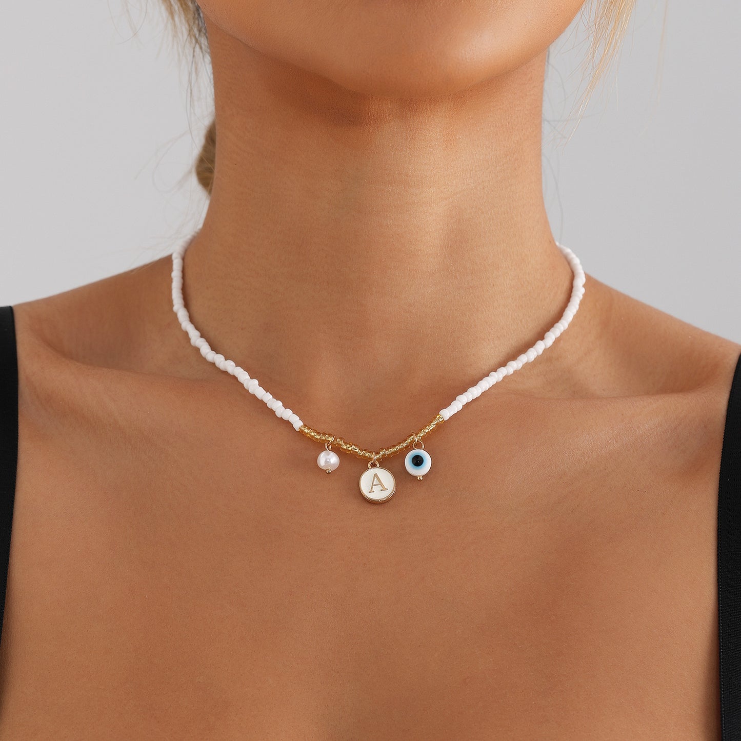 Bohemian White Beaded Necklace with Alloy Letter Eye Pendant on Clavicle Chain