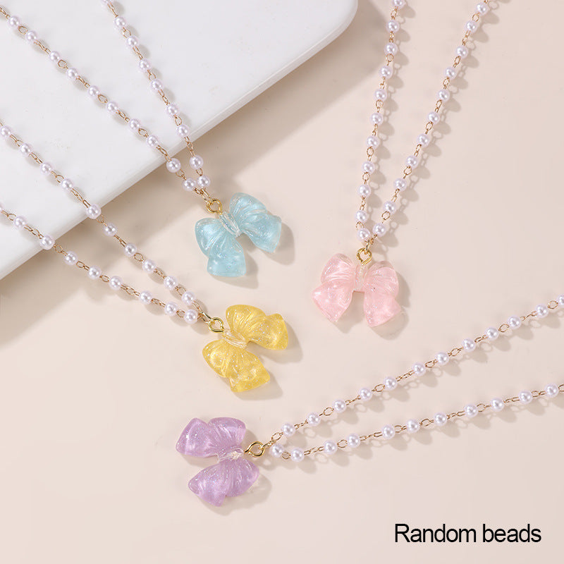 Conjunto de collar minimalista de lazo y corazón para niñas con colgante de resina en cadena de cuentas Colección de Verano