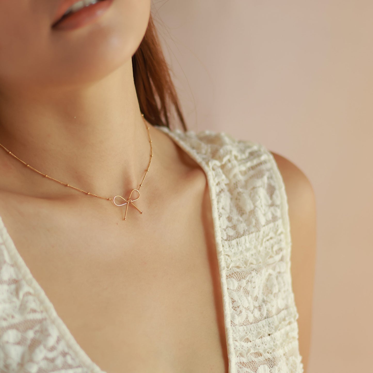Parure Collana e Bracciale da Donna con Fiocco in Acciaio al Titanio Placcato Oro 18K