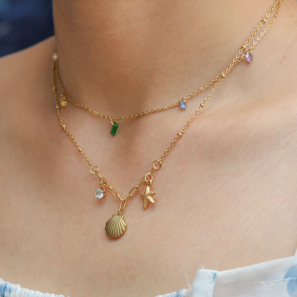 Collar con colgante de concha y estrella minimalista inspirado en el océano en acero inoxidable con baño de oro de 18 quilates en cadena O
