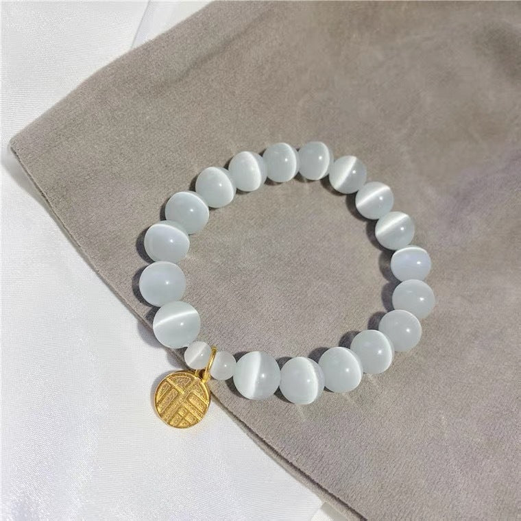 Bracciale da donna placcato in titanio e acciaio, con design floreale minimalista, pietra occhio di gatto e ciondolo portafortuna Fu