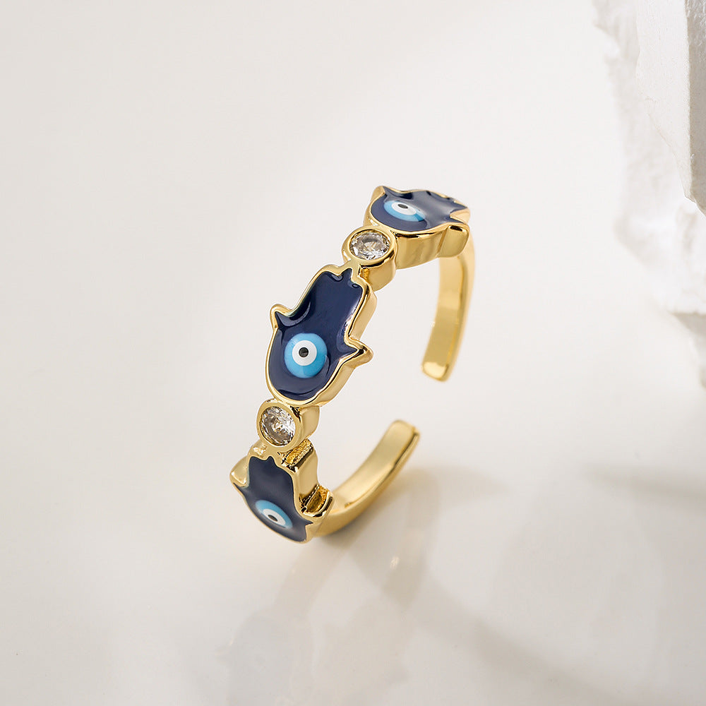 Anello da donna in rame con placca in oro 18K, finitura smaltata e intarsio in zircone, design Mano di Fatima