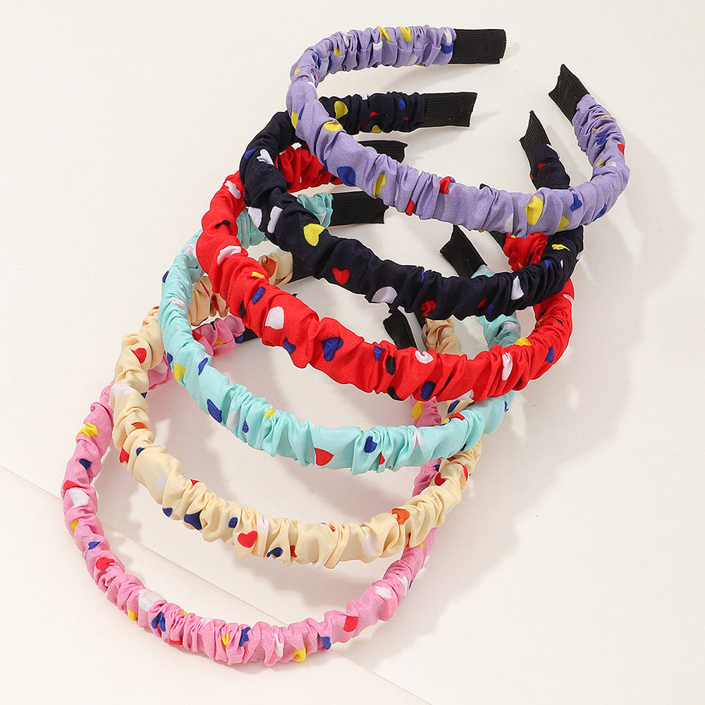 Bonita diadema de resina plástica con estampado de corazones para niños con acabado artesanal en forma geométrica